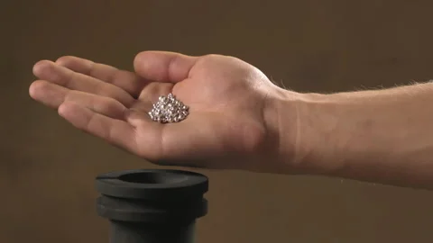 Hand staged throws silver pieces Stock Footage 196174420