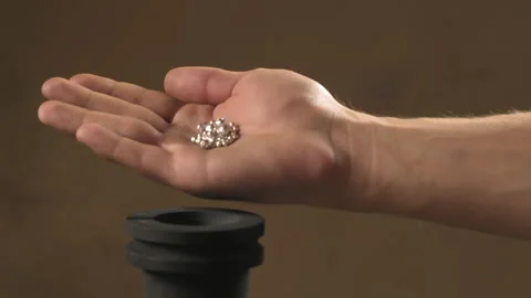 Hand staged throws silver pieces Stock Footage 196174471