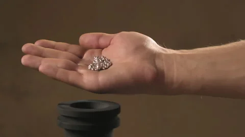 Hand staged throws silver pieces Stock Footage 196174507