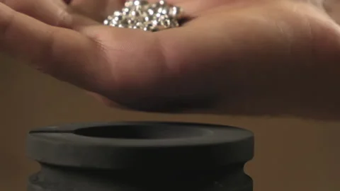 Hand staged throws silver pieces Stock Footage 196174587