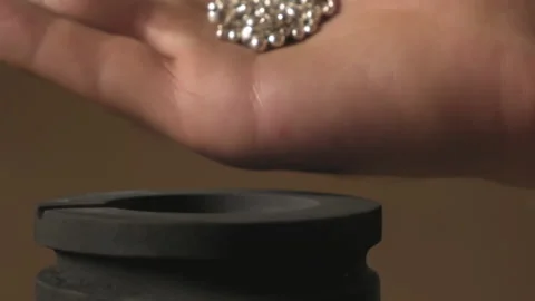 Hand staged throws silver pieces Stock Footage 196174657