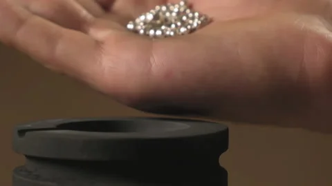 Hand staged throws silver pieces Stock Footage 196174689