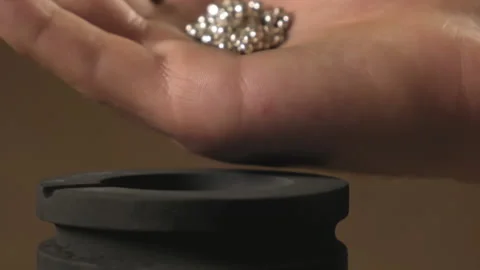 Hand staged throws silver pieces Stock Footage 196174703