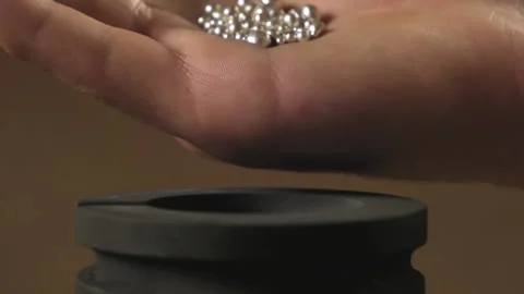 Hand staged throws silver pieces Stock Footage 196174778