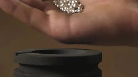 Hand staged throws silver pieces Stock Footage 196174799