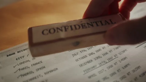 Hand stamp document as confidential relating to bank account sensitive activity Stock Footage 242426368