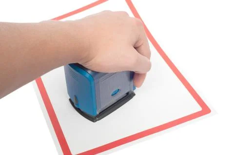 Hand with stamp for documents and paper on white background 写真素材