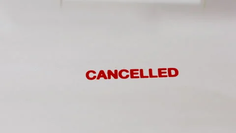 Hand stamp the word Cancel plastic stamper. with a red stamp on white paper. Stock Footage 303369447