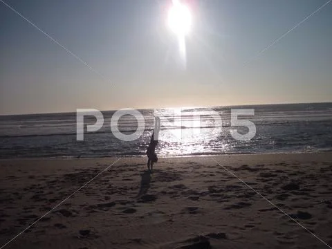 Hand-standing on the beach Stock Photos