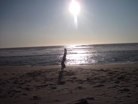 Hand-standing on the beach Stock Photos