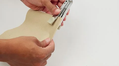 Hand Stapling a Sheet of Paper Stock Footage 327851674