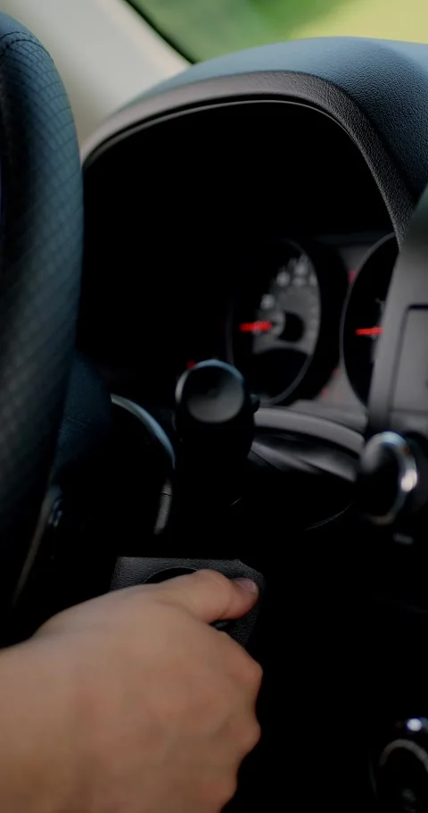 Hand starting a car by turning the ignition key, close up... Stock Footage 313951042
