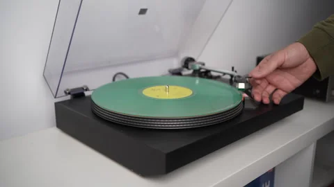 Hand starting vinyl record on turntable Stock Footage 285946681