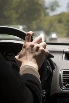Hand on steering wheel Stock Photos