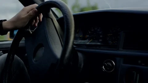 Hand on Steering Wheel While Driving a Car, Daylight Interior, Close Up Shot Stock Footage 341517388