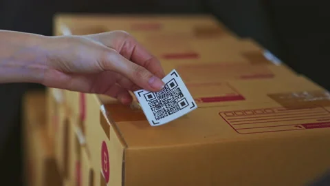 Hand sticking barcode bar on packing boxes for products. 스톡 동영상 153957468