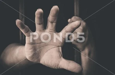 A hand sticking out of a detention attempt. Stock Photos