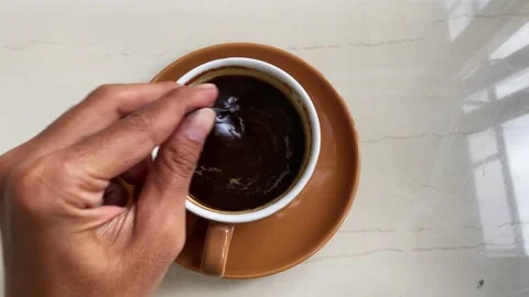 Hand Stirring Black Coffee with Spoon Stock Footage 319030778