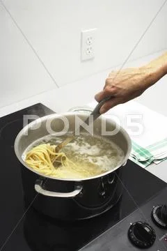 Hand Stirring Boiling Pasta Stock Photos
