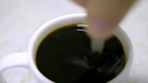 HAND STIRRING COFFEE IN WHITE CUP WITH SPOON Stock Footage 150337522