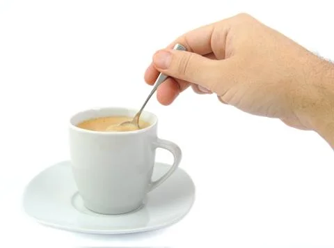 Hand stirring a cup of coffee Foto stock