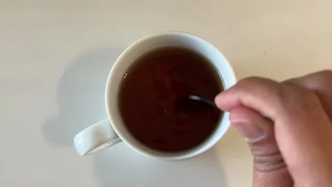 Hand Stirring Hot Black Tea In White Ceramic Cup Stock Footage 343141733