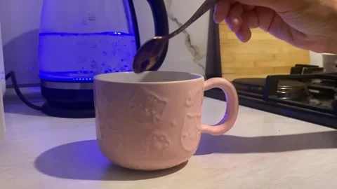 Hand stirring hot drink close-up in a ceramic mug Stock Footage 345361709