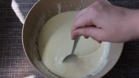 A hand is stirring the pancake batter Stock Footage 133398953