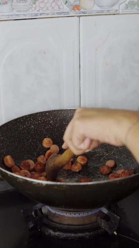 Hand stirring sausage Video stock 247084637