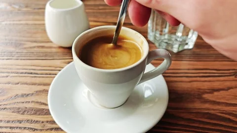 Hand stirring sugar in coffee Video stock 276437647