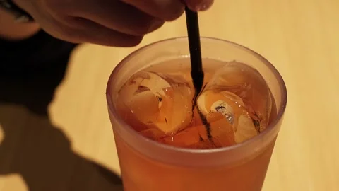 Hand stirs iced tea Stock Footage 338347985