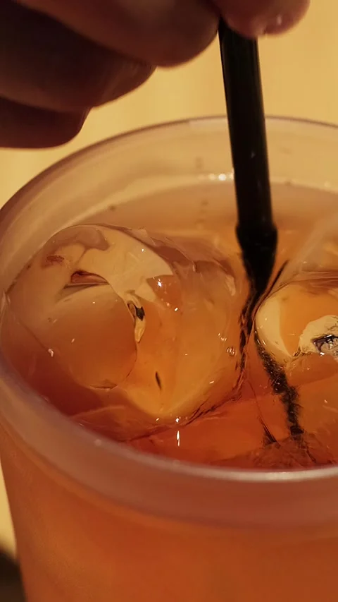 Hand stirs iced tea Stock Footage 338347987