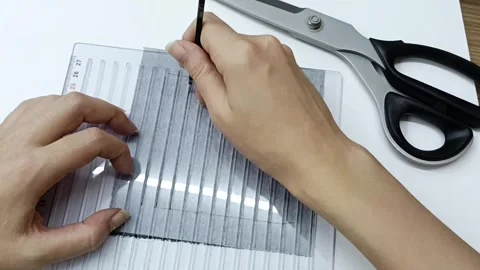 Hand stitching geometric embroidery pattern on dark fabric close up Video stock 330050573