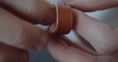 Hand stitching a leather loop for a belt close-up Stock Footage 146137824