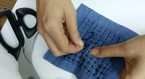 Hand stitching sashiko embroidery pattern on blue fabric Stock Photos