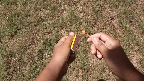Hand striking a match and creating a bright, burning flame. Stock Footage 313728675