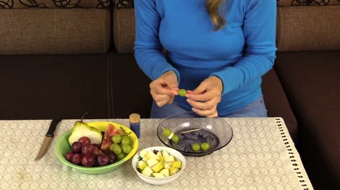 Hand string grape pear fruit on  stick and put pan on table Stock Footage 42896253