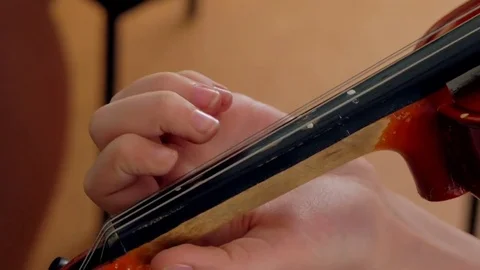 Hand on the strings of a violin Stock Footage 78234838
