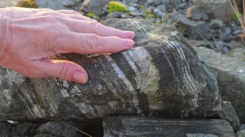 A hand strokes the patterns on a beautiful granite stones. Stock Footage 341895908
