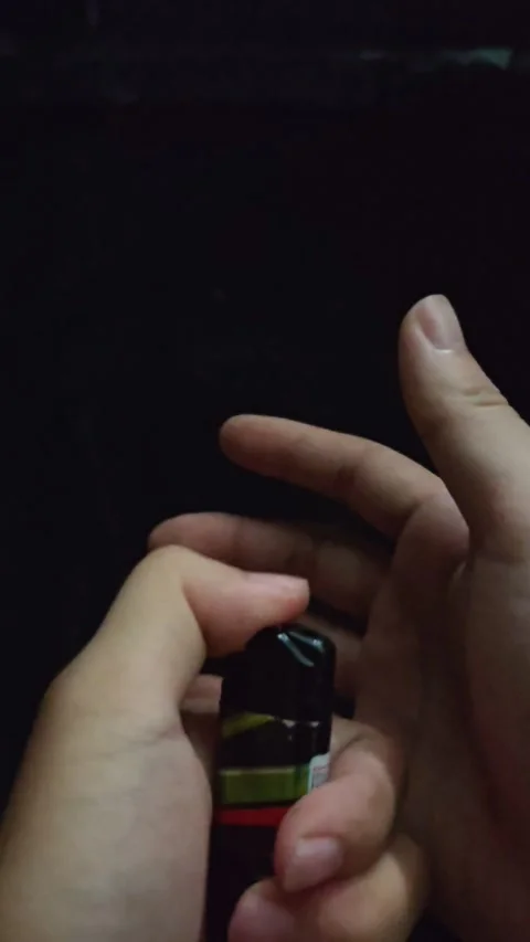 Hand Struggling to Ignite a Lighter in Pitch Black Darkness Stock Footage 346363867