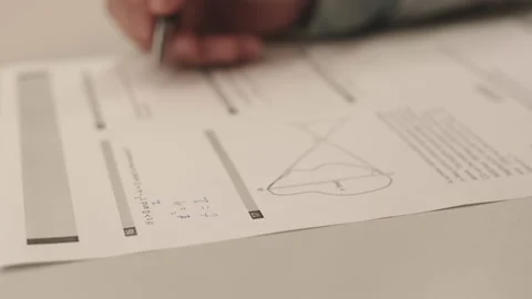 Hand of Student Solving Problems on Paper Stock Footage 153208553