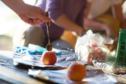 Hand Stuffing Chocolate Chips Into Apple In Shed Stock Photos