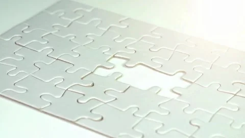 Hand successfully inserts correct puzzle piece into complex puzzle Piece of Stock Footage 336248562