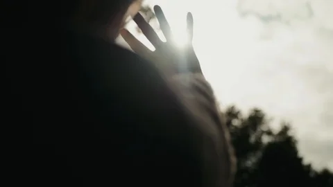 Hand sun shines through the palm forest hide hidding near head Stock Footage 101690261