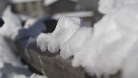 A hand in super slow motion moves snow from a snowy handrail 스톡 동영상 295292739