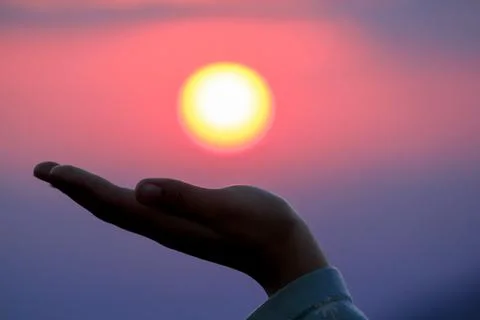 Hand supporting the sun Stock Photos