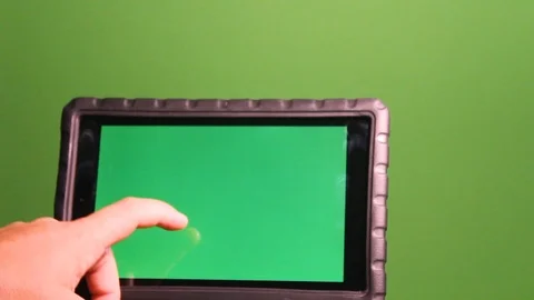 Hand swipes left and right on Ipad with green screen image and green Stock Footage 120819607