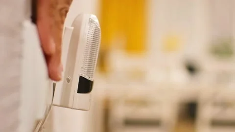 Hand switch on light in kitchen room. Special device connects power source .. Stock Footage 226459770