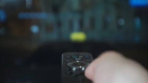 Hand switches telecasts using the remote control. Stock Footage 130411434