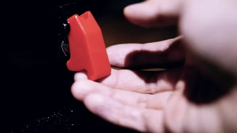 Hand Switching on and off a Toggle Switch with a cover. Stock Footage 100403545